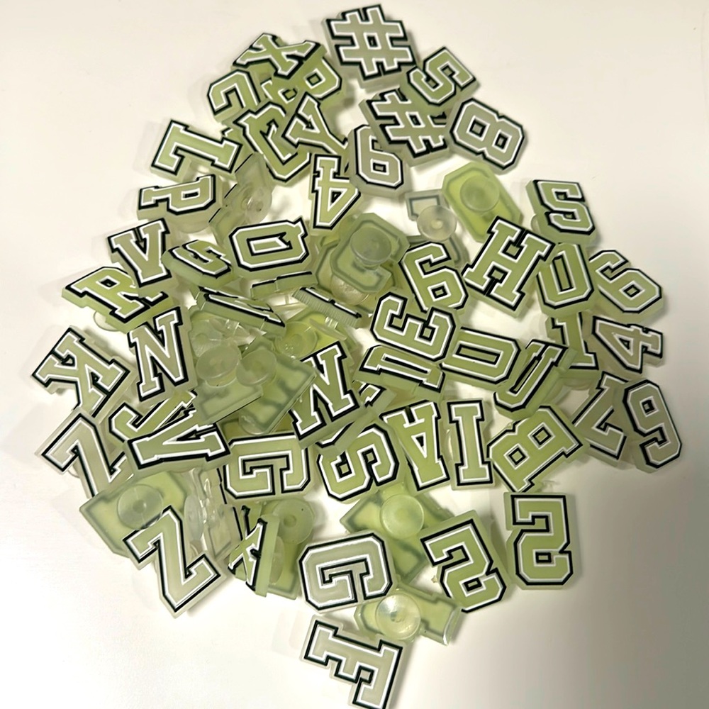67 assorted jibbitz (glow in the dark numbers and letters)